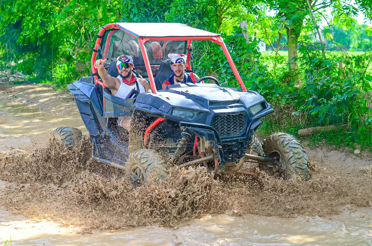 A buggy splashing through mud on a trail